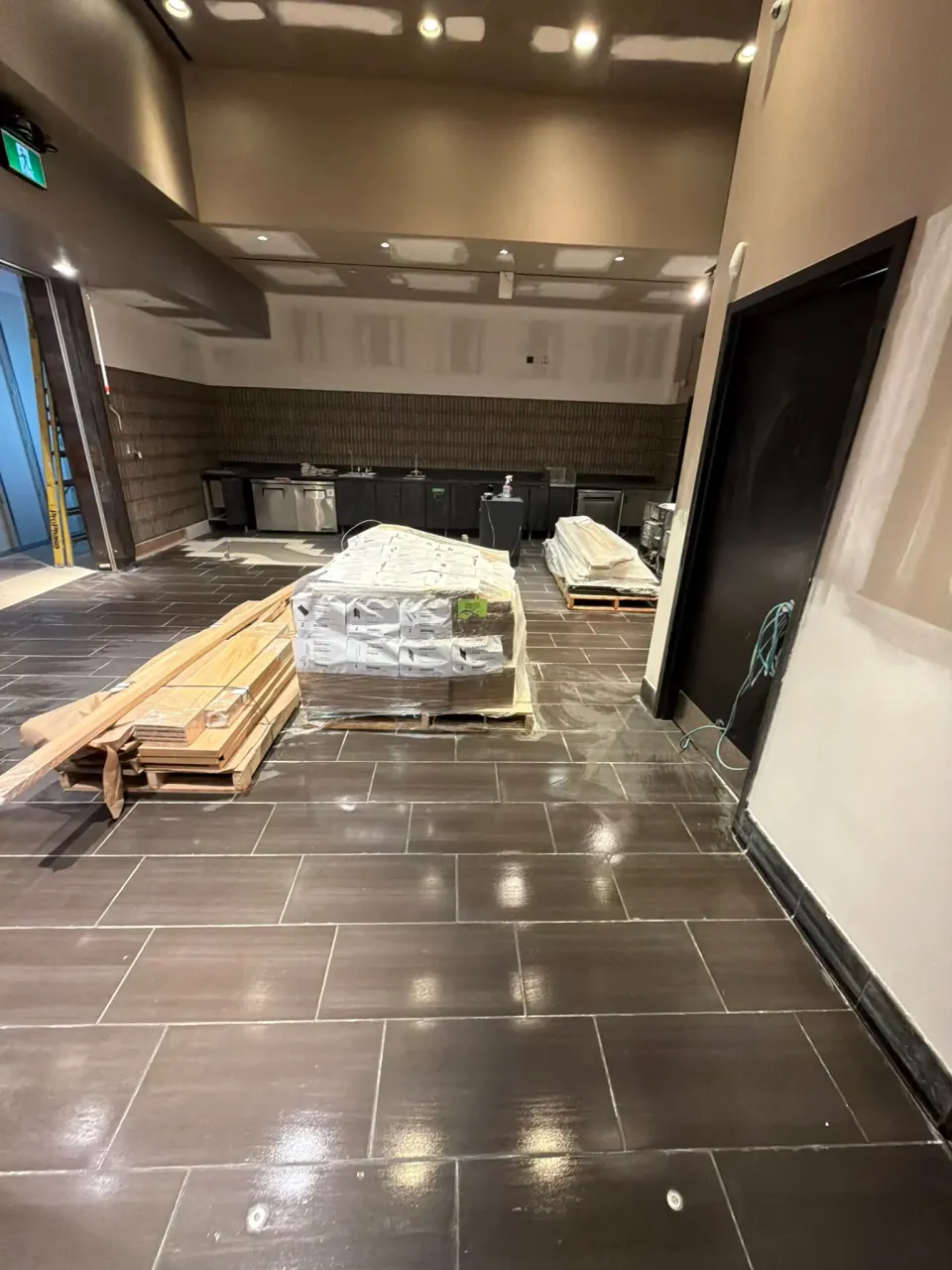 Commercial service area with unfinished wall and materials during renovation