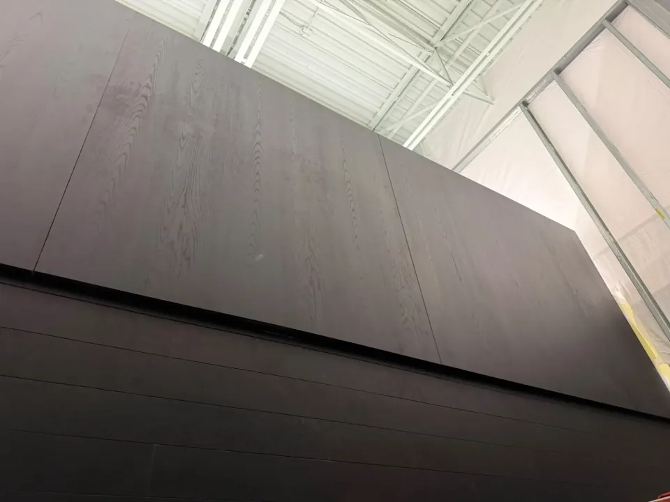 Dark cladding installed across the upper commercial wall
