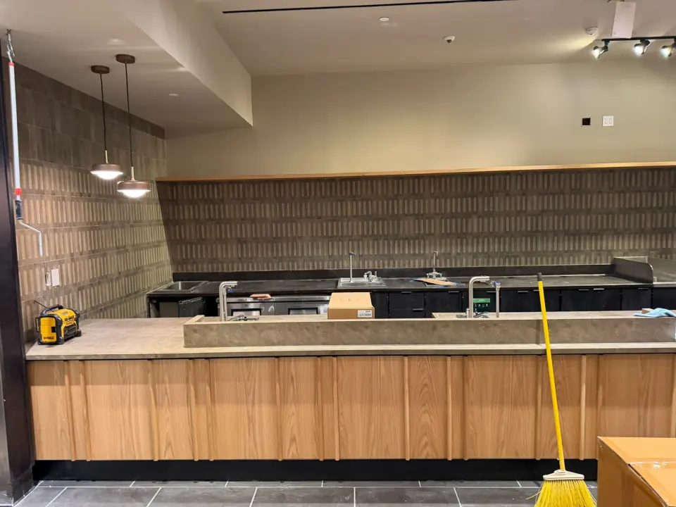 Commercial service counter with wood finish and dark wall detailing