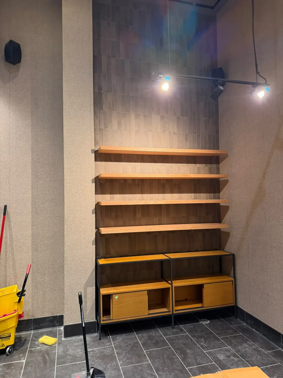 Interior wall detailing with wood shelves and lower cabinets